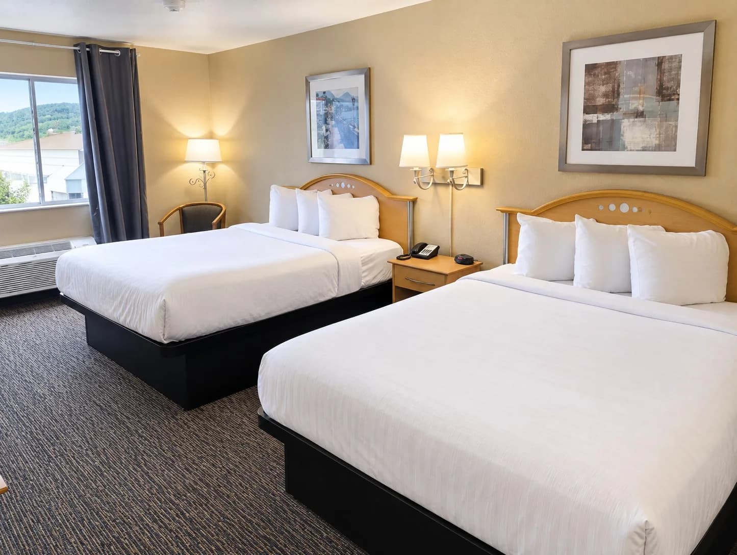 Two Queen Room — Room with two queen beds, white linens and a window