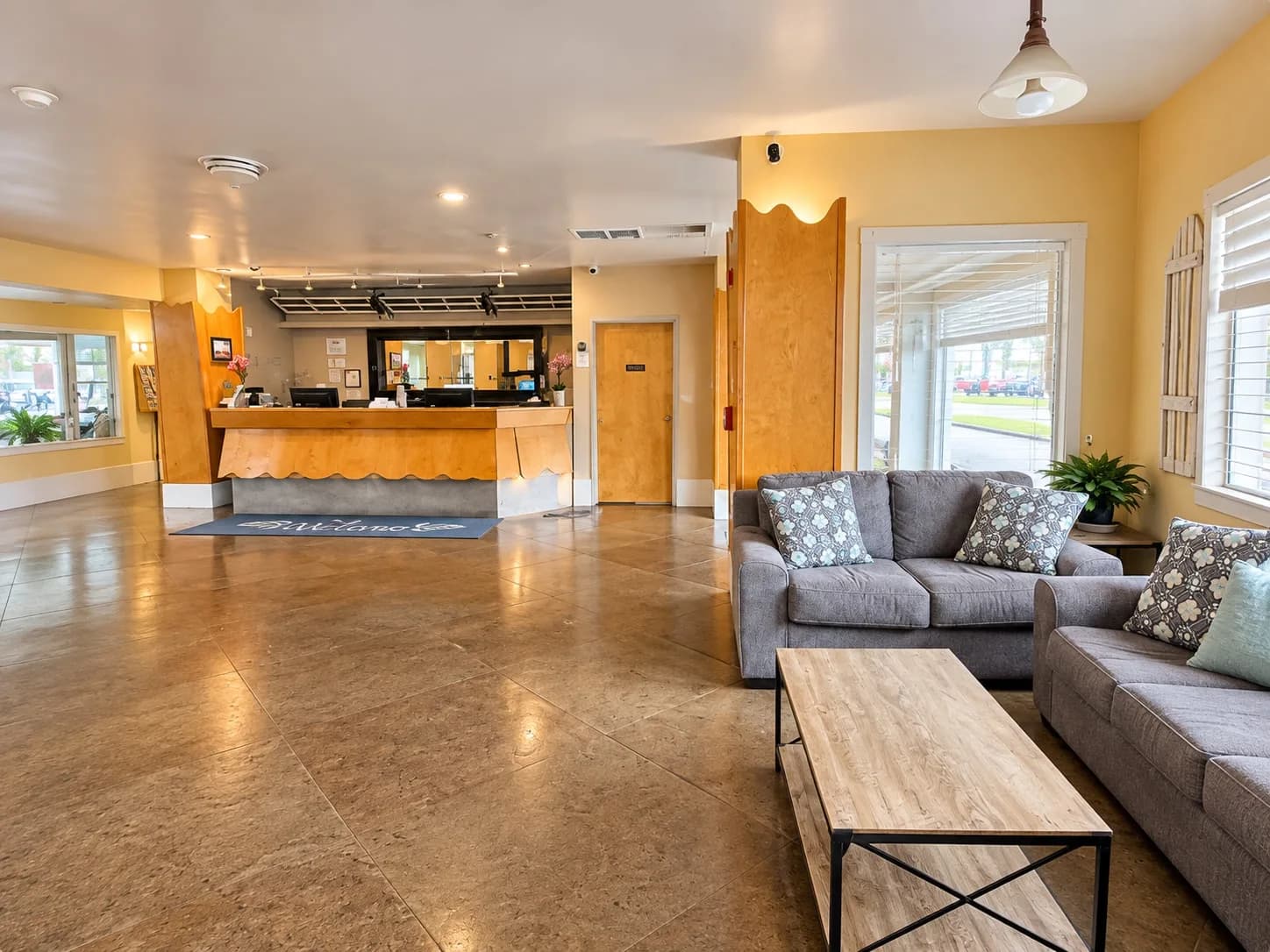 Lobby with the 24-hour front desk and a sofa seating area
