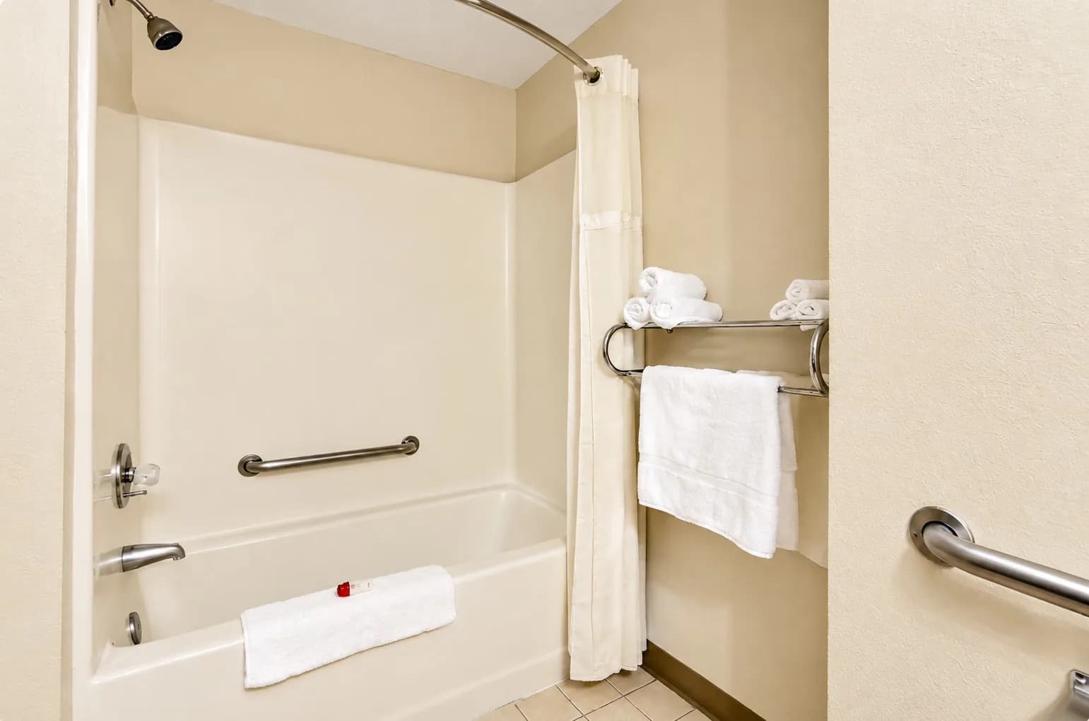 Accessible King Room — Tub and shower with grab bars and fresh towels