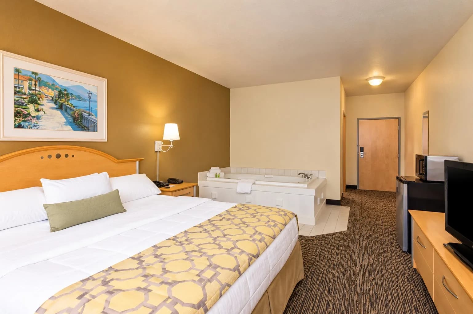 King Whirlpool Suite — Whirlpool suite with a king bed and an in-room jetted tub